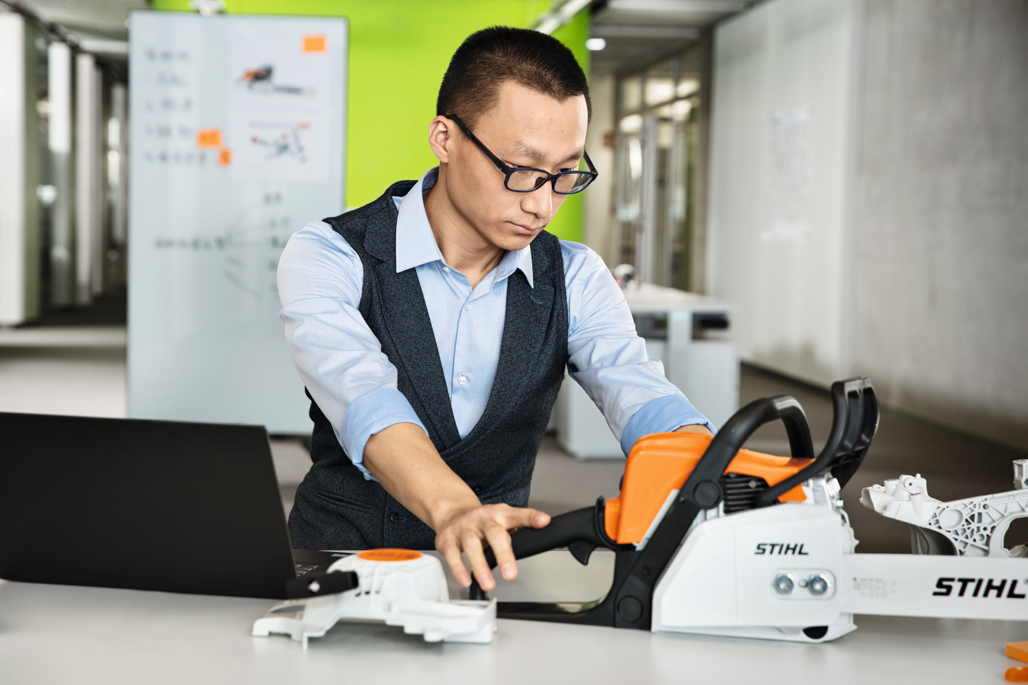 STIHL employee inspecting a chainsaw